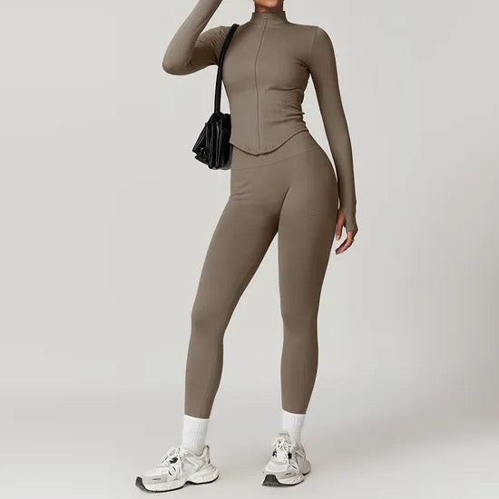 Person wearing a brown gym clothing outfit with white sneakers on a plain background